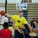 University of Michigan basketball player Nik Stauskas dribbles a ball while campers hang on him during the shooting academy on Tuesday, July 9. Daniel Brenner I AnnArbor.com